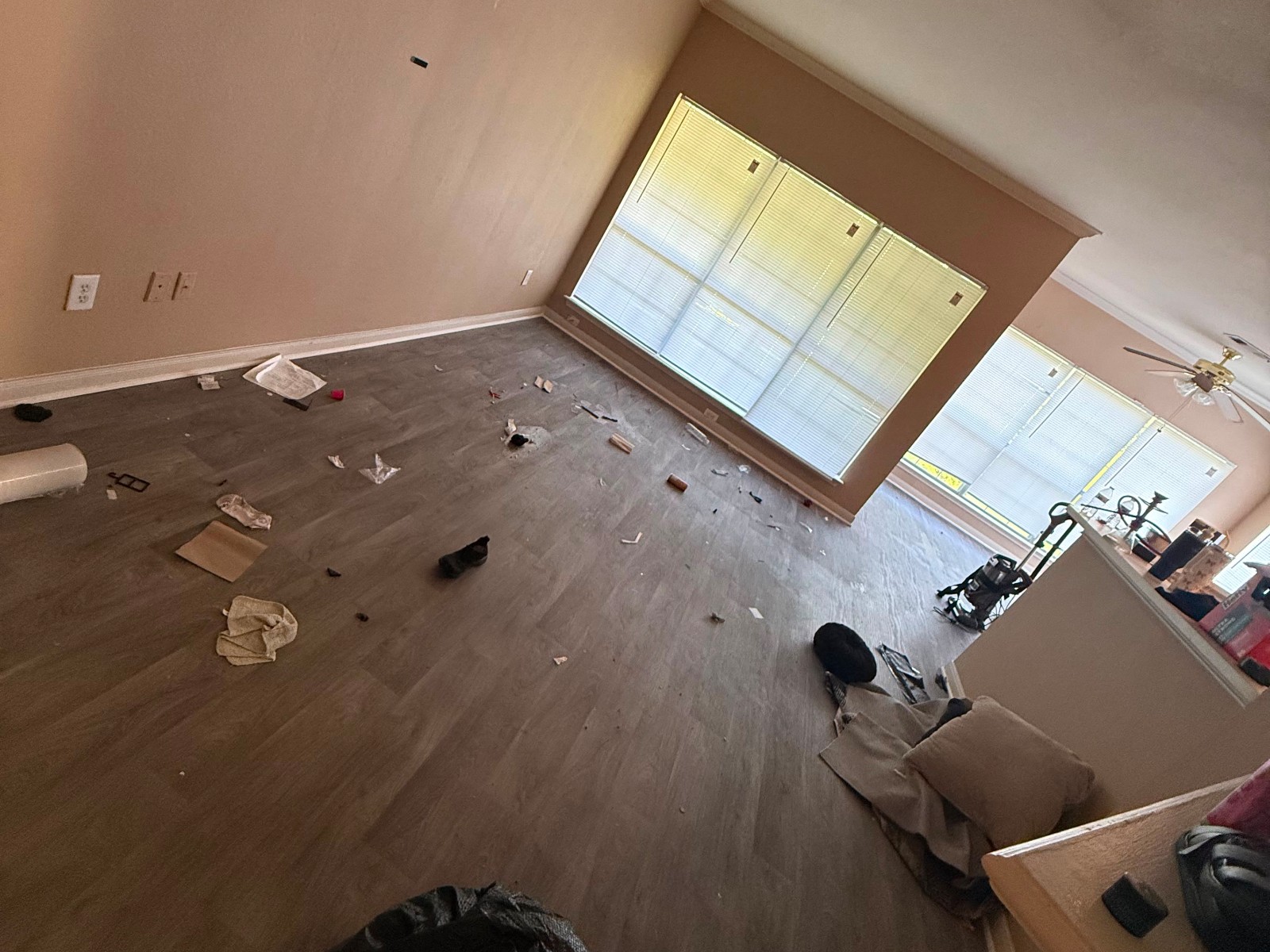 Living room floor covered in debris before cleaning